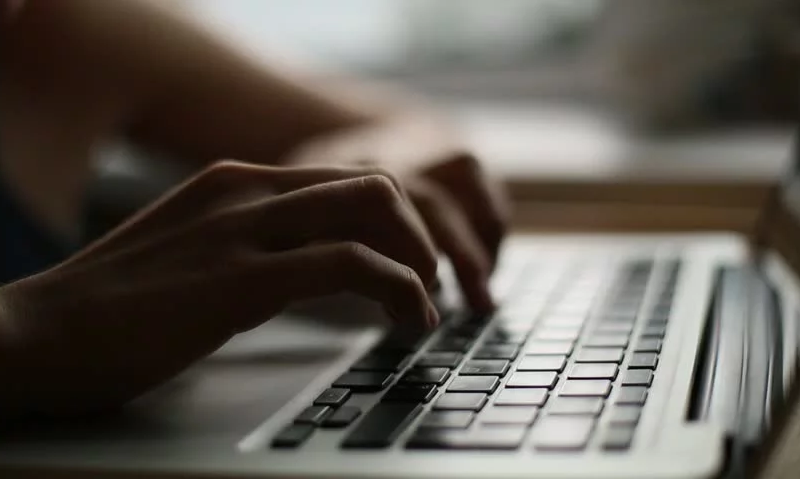 Hands typing on keyboard