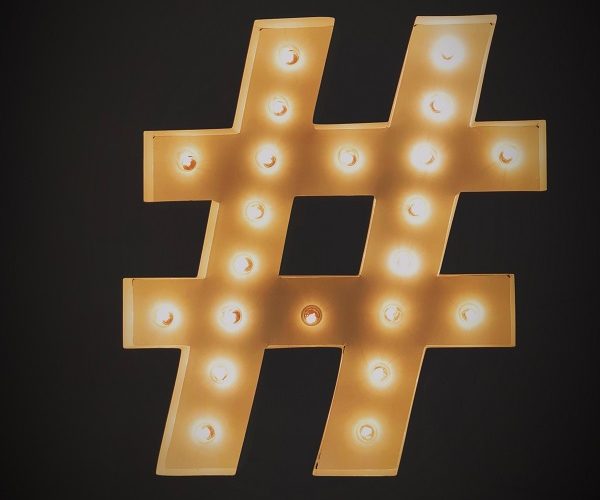 Gold hashtag light fitting on black background